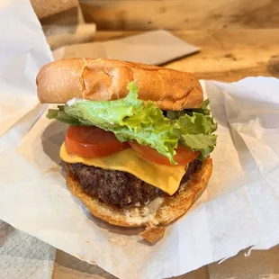 a hamburger with lettuce, tomato, and cheese