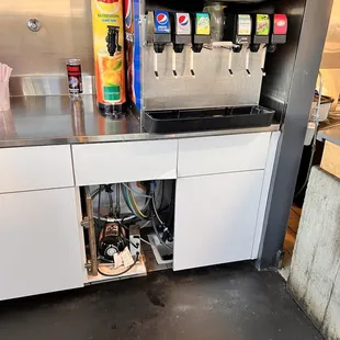 a soda dispenser in a commercial kitchen