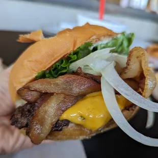 Bacon Cheesy TrueBurger. $10.50. 5 oz burger, medium, garlic mayo, lettuce, tomato, onion, pickles.