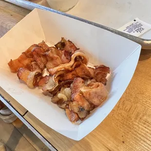 Partially cooked bacon which should have been on my burger in the first place. Not crispy but soggy.