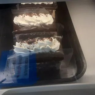 a chocolate cake with white frosting and sprinkles