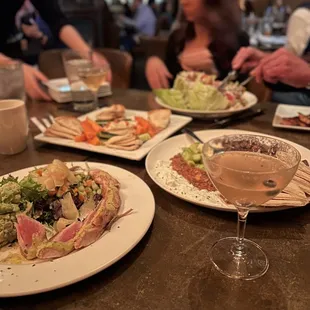 plates of food and a glass of wine