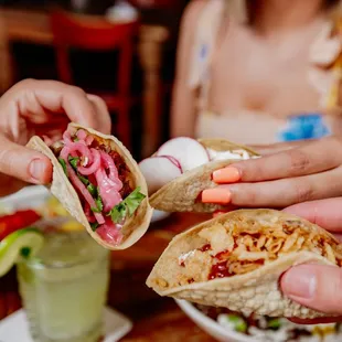a person holding a sandwich in their hand