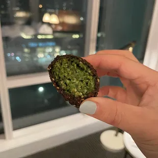 a hand holding a piece of food