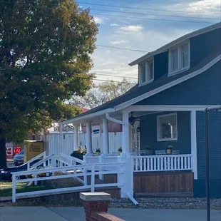 a blue house with a white porch