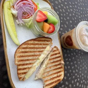 Swiss and turkey panini with a side of fruit and a sugar free caramel macchiato