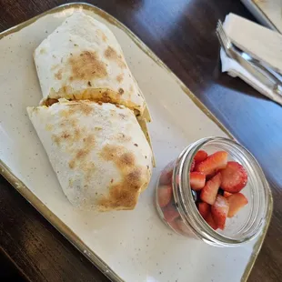 a burrito and strawberries