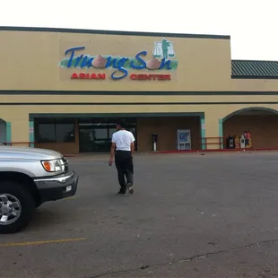 a man walking in front of a store