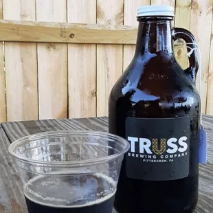 a glass of beer and a growler