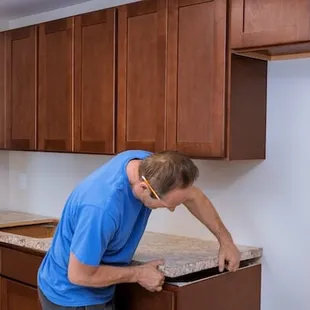 a man working on a kitchen counter