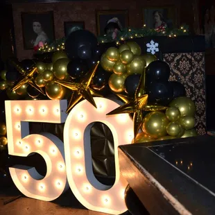 the number 50 surrounded by balloons