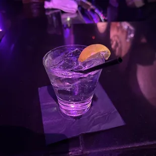 a glass of water with a slice of lemon