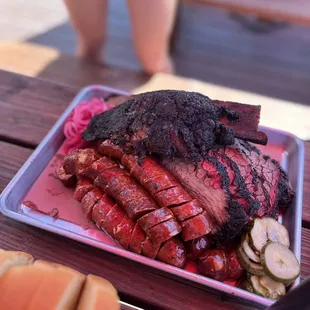 a plate of barbecued meat on a picnic table