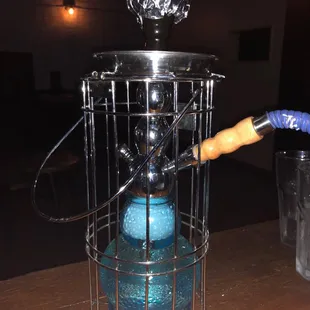 a blue glass in a cage