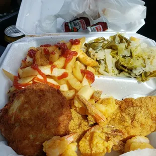 Crab cake, fried shrimp, fish, fries and cabbage