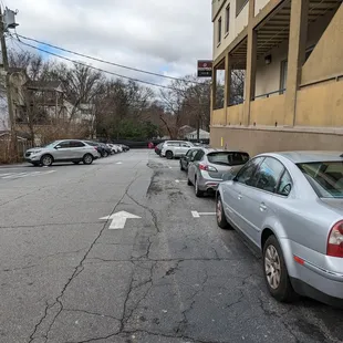 Outside. Parking lot driveway. Follow ParkSimple signs to pay. Not all hours are enforced. We came for Sunday lunch and parking was free.