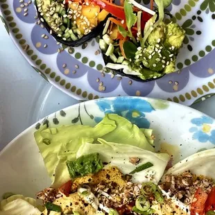 a plate of salad and a bowl of dressing
