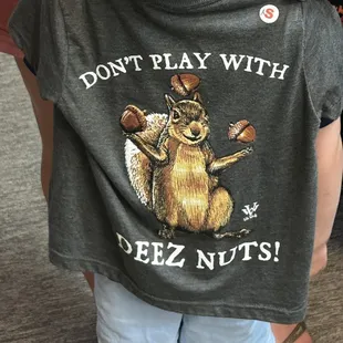a child wearing a don't play with deez nuts t - shirt