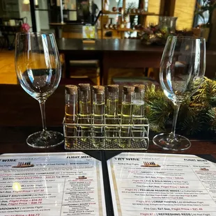 a menu and wine glasses on a table