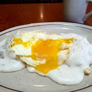Gravy and biscuit with a runny egg