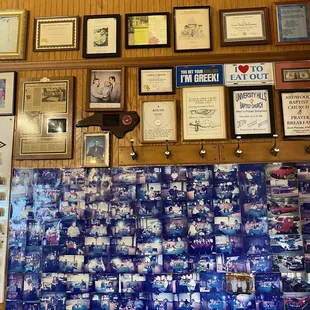 a wall full of framed photos