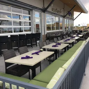 Interior garage doors open to an extensive heated outdoor patio.