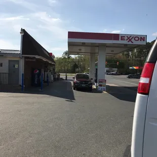 a gas station with a car parked in front of it