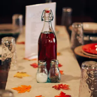 a table setting with a bottle of syrup