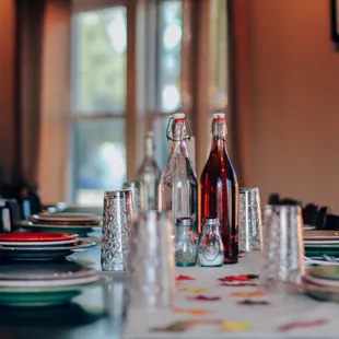 a table set with wine bottles and glasses