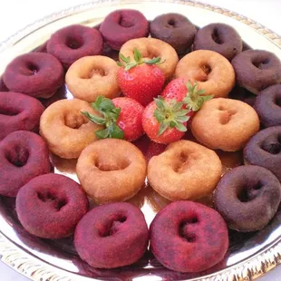Layout of Red-Velvet, Chocolate and Strawberry Shortcake flavored donuts...with a Strawberry op top.