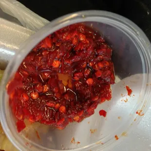 (Burn so good) chili paste, i.e. hot sauce. I think it has a hint of sweet to it and it is RED RED.