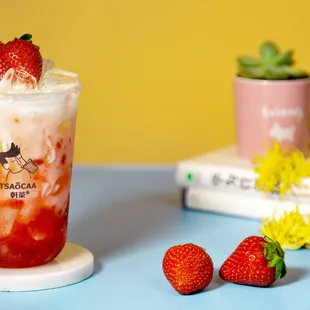 a strawberry milkshake with whipped cream and strawberries