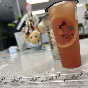 Grapefruit and Peach Green Tea with Grapefruit Jelly in the front. Taro Bubble Milk in the back.