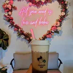 a hand holding a cup of iced coffee