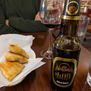 a bottle of beer and pastries