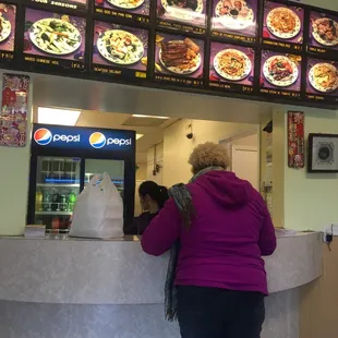 a woman ordering food at a fast food restaurant