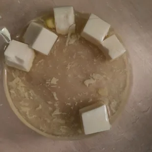 Short, dark hair on a piece of tofu (bottom right), in my egg drop soup.