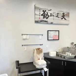 a kitchen with black cabinets and white walls