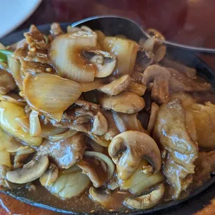 Sizzling Beef &amp; Scallops after it cooked on the iron plate.
