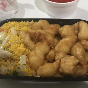 Sweet and sour chicken special combination platter with chicken fried rice (substitute for pork fried rice) and an egg roll.