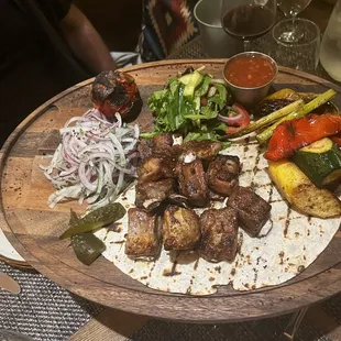 a platter of meat and vegetables