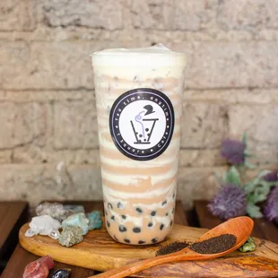 a cup of bubble tea on a wooden table