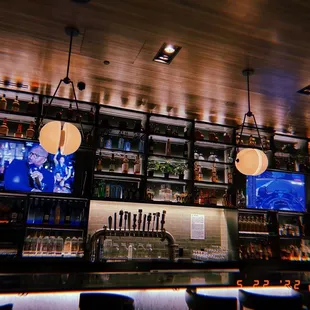 a bar with a lot of bottles on the shelves