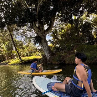 After standing, we all sat and paddled to feel the water. We saw several large turtles swimming.