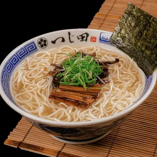 a bowl of ramen with noodles and seaweed