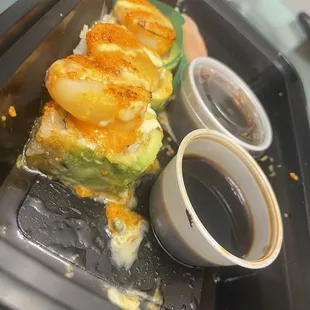 a sushi roll with shrimp and avocado