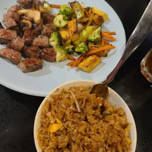 a plate of beef, rice, and vegetables