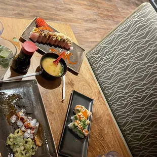 a variety of sushi dishes on a table