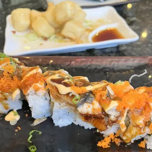 two plates of sushi and a plate of dumplings