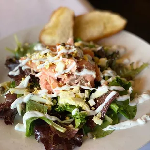 a salad with salmon and lettuce
